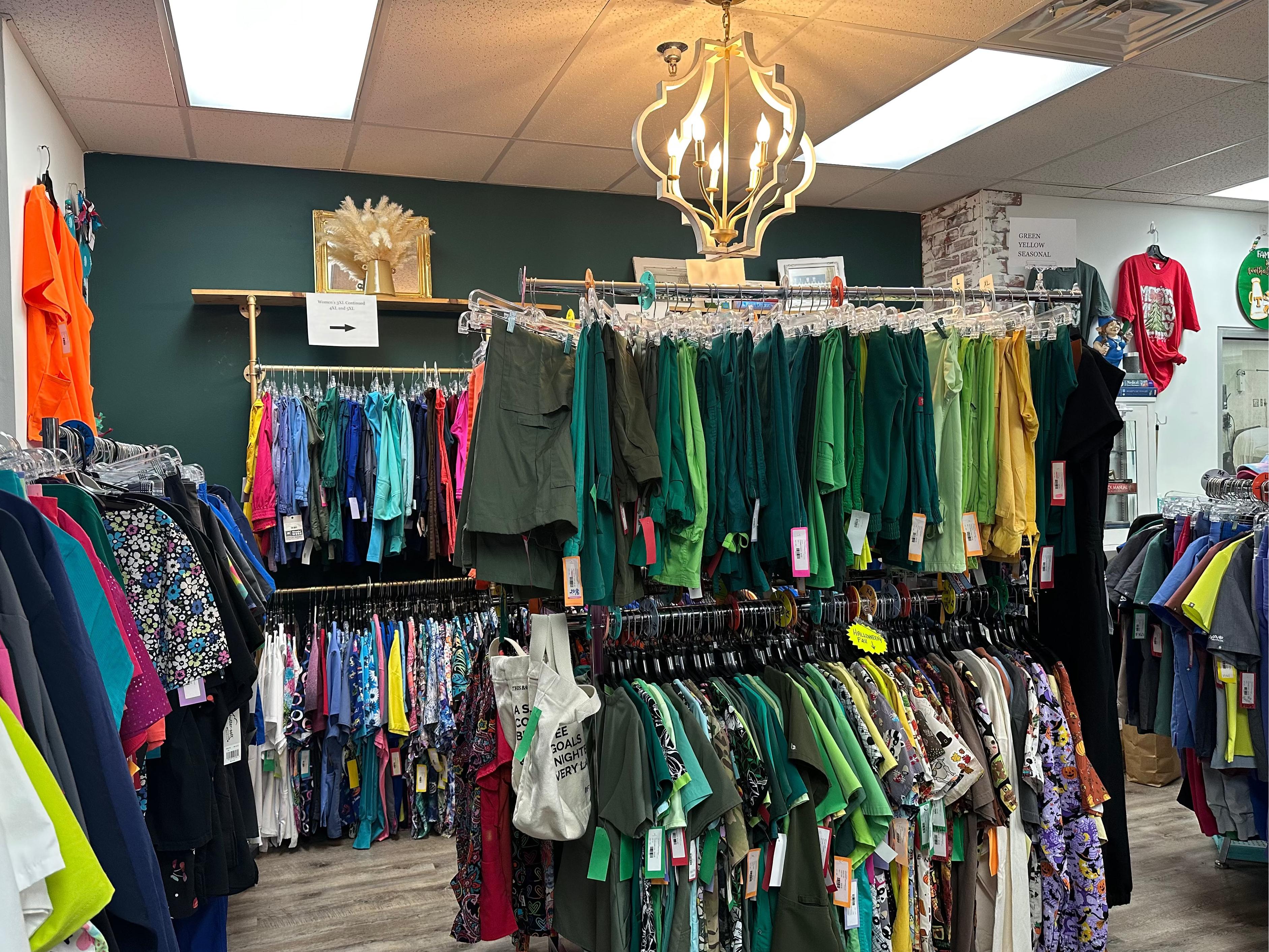 Clothing store with racks of colorful shirts and dresses on display.